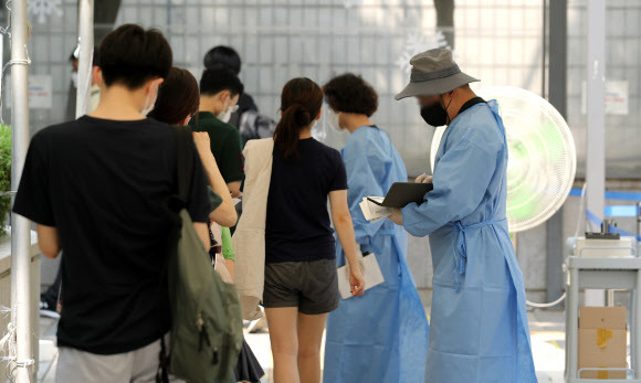 국내 코로나19 하루 신규확진자 수가 전주 대비 8253명 급증해 1만 8147명을 기록한 5일 오전 서울 서초구보건소 선별진료소에서 검사 대상자들이 pcr 검사를 기다리고 있다. 2022.07.05. 뉴시스