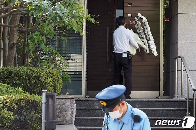 아베 신조 전 일본 총리가 선거 유세중 총에 맞고 숨진 다음날인 9일 일본 도쿄의 아베 전 총리 자택에 화환이 들어서고 있다. © AFP=뉴스1 © News1 이성철 기자