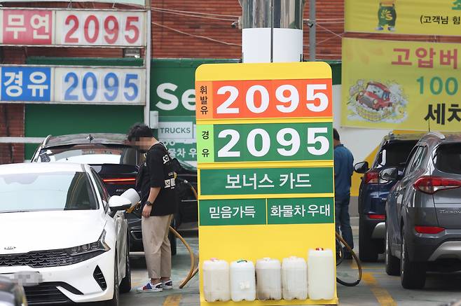 지난달 26일 휘발윳값이 리터당 2000원 초반대인 서울시내 한 주유소가 기름을 넣으러 온 고객들로 붐비고 있다. [연합]