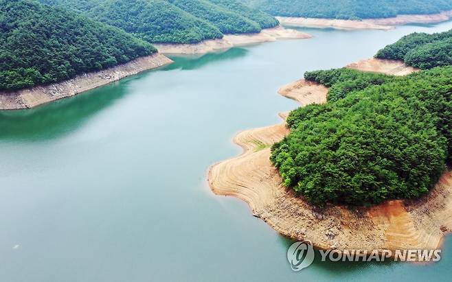 말라가는 주암댐 (순천=연합뉴스) 천정인 기자 = 8일 오전 전남 순천시 주암댐의 수심이 낮아져 갈색 수면선이 드러나 있다. 섬진강 수계 다목적댐인 주암댐은 이날부터 가뭄 주의 단계에 진입했다. 이날 오전 기준 저수율은 24%를 기록하고 있다. 2022.7.8 iny@yna.co.kr