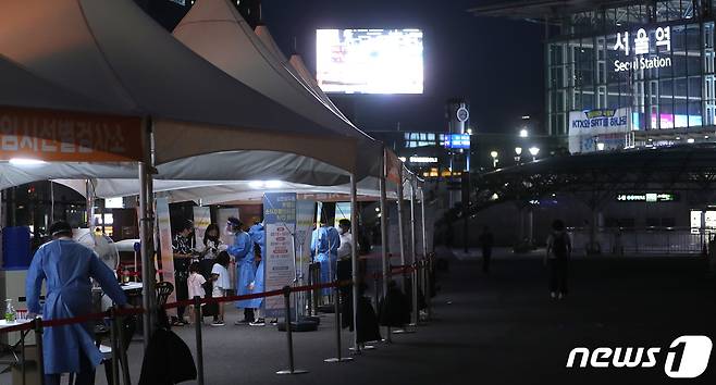 신종코로나바이러스 감염증(코로나19) 확산세가 계속된 25일 저녁 서울역 임시선별진료소를 찾은 시민들이 검사 대기를 하고 있다. 방역당국에 따르면 이날 오후 6시 기준 코로나19 신규 확진자는 8만3018명으로 동시간 기준으로 98일만에 최다 확진자가 발생했다. 2022.7.25/뉴스1 © News1 이성철 기자