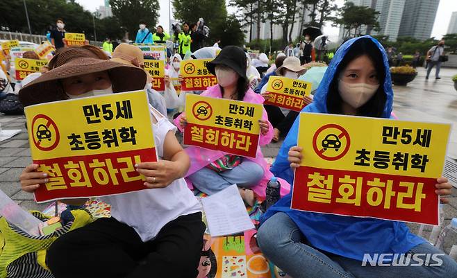 [서울=뉴시스] 이영환 기자 =  2일 오후 서울 용산구 대통령 집무실 인근에서 열린 전국국공립유치원교사노동조합, 교사노동조합연맹 등이 주최한 만5세 조기취학 반대를 위한 총궐기대회에서 참가자들이 피켓을 들고 있다. 2022.08.02 20hwan@newsis.com