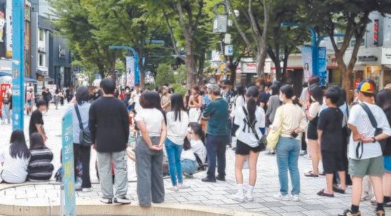지난 1일 서울 홍대입구역 주변 거리에서 젊은이들이 공연을 보고 있다. 김성탁 기자