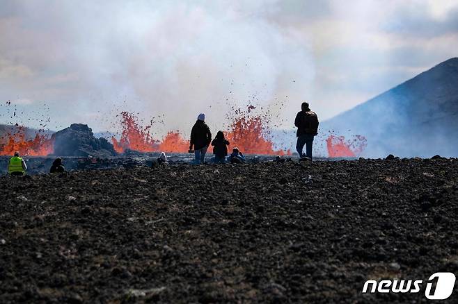 4일(현지시간) 아이슬란드 레이캬네스 반도의 그린다비크에 있는 파그라달스퍄들 화산이 8개월 만에 활동을 재개해 용암을 뿜어내는 모습을 보기 위해 주민들이 접근을 하고 있다. ⓒ AFP=뉴스1 ⓒ News1 우동명 기자
