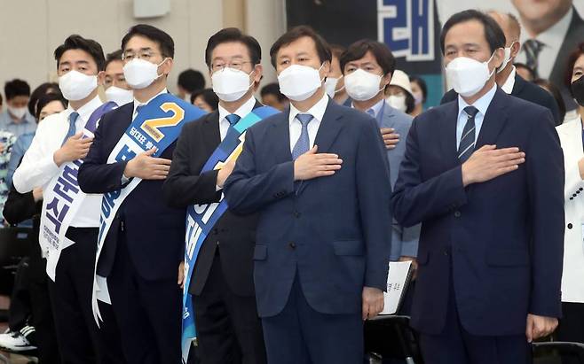 더불어민주당 대표 후보들이 13일 부산 동구 부산항컨벤션센터에서 열린 민주당 당대표 및 최고위원 후보자 부산 합동연설회에 참석, 국민의례를 하고 있다. 왼쪽부터 강훈식, 박용진, 이재명 후보. / 사진제공=뉴시스