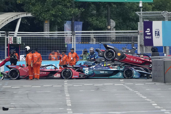 Track marshalls work near the cars of Avalanche Andretti Formula E's driver Oliver Askew of the U.S., 28, Nio 333 Formula E Team's driver Oliver Turvey of Britain, 3, and Nissan e.dams' driver Sebastien Buemi of Switzerland, 23, after they crashed during the Seoul E-Prix Formula E auto race round 15 in Seoul, South Korea, Saturday, Aug. 13, 2022. (AP Photo/Lee Jin-man)