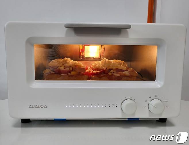 취재진이 쿠쿠 스팀 토스터기를 이용해 피자 토스트를 굽고 있다. ⓒ 뉴스1