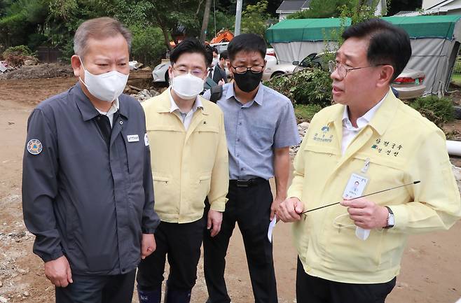 이상민 행정안전부 장관이 14일 오전 경기 양평군 강하면 성덕천 수해현장을 찾아 전진선 군수로부터 도로 등 공공시설 피해 현황을 보고받고 있다.(행정안전부 제공)/뉴스1