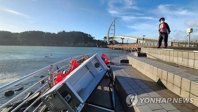 태풍에 날라온 냉장고 (제주=연합뉴스) 한상균 기자 = 6일 오전 서귀포항 새연교에서 한 해녀가 지난 밤 태풍 힌남노에 날라온 다리 인근 식당 냉장고를 보고 있다. 2022.9.6 xyz@yna.co.kr