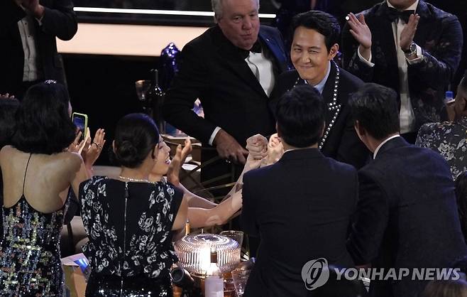 에미상 남우주연상 이정재 축하하는 '오징어 게임' 제작진 (로스앤젤레스 AP=연합뉴스) 드라마 '오징어 게임'의 제작진들이 12일(현지시간) 미국 로스앤젤레스 마이크로소프트 시어터에서 열린 제74회 에미상 시상식에서 드라마 부문 남우주연상을 받은 배우 이정재를 축하해주고 있다. 2022.9.13 alo95@yna.co.kr