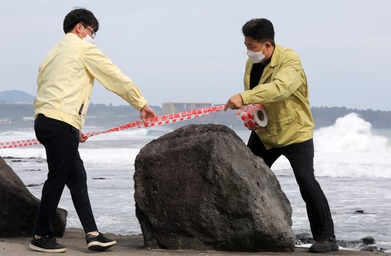 제14호 태풍 난마돌(NANMADOL)이 북상 중인 18일 오후 제주 서귀포시 하예동 해안으로 거친 파도가 몰려드는 가운데 공무원들이 통제선을 설치하고 있다. 뉴스1