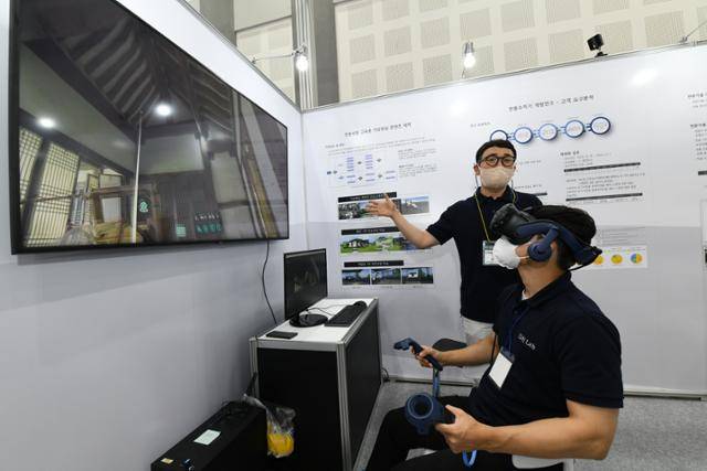 한국전통문화대학교 소속 이환욱(오른쪽) 연구원이 김기홍(왼쪽) 연구원과 함께 15일 경북 경주시 경주화백컨벤션센터에 마련된 ‘2022 국제문화재 산업전’ 전시장에서 가상현실(VR) 기기를 활용한 전통 베틀 베짜기 콘텐츠를 시연하고 있다. 문화재청 제공