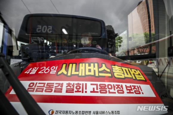 서울 시내버스 노조가 26일 총파업을 예고한 가운데 25일 오전 서울 중구 서울역버스환승센터를 지나는 버스에 파업 관련 피켓이 놓여있다. [사진=뉴시스]