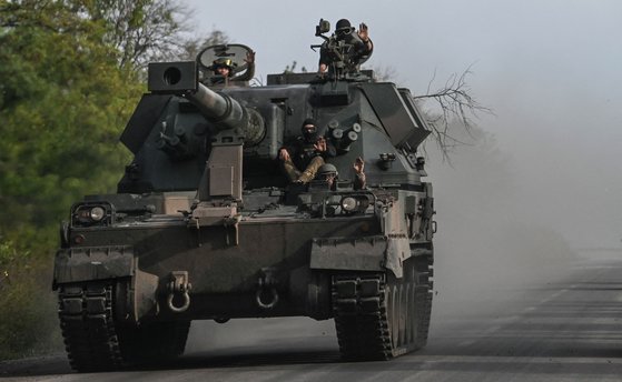 지난 22일(현지시각) 우크라이나 동부 지역에서 우크라이나 군인들이 탱크를 타고 있다.AFP=연합뉴스