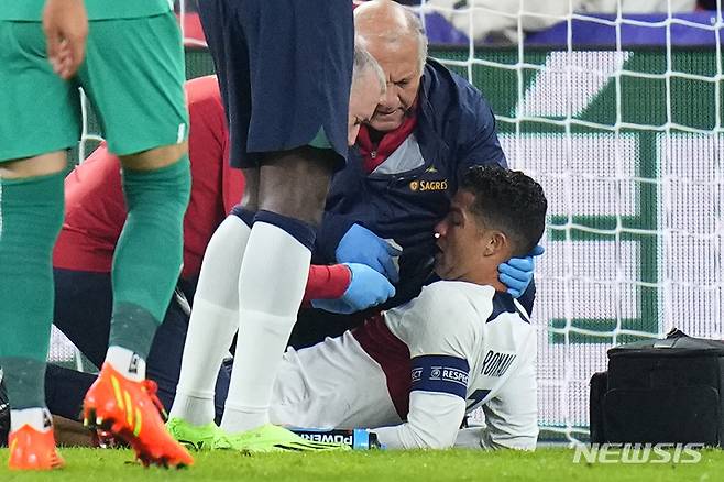 Portugal's Cristiano Ronaldo is treated on the pitch during the UEFA Nations League soccer match between the Czech Republic and Portugal at the Sinobo stadium in Prague, Czech Republic, Saturday, Sept. 24, 2022. (AP Photo/Petr David Josek)