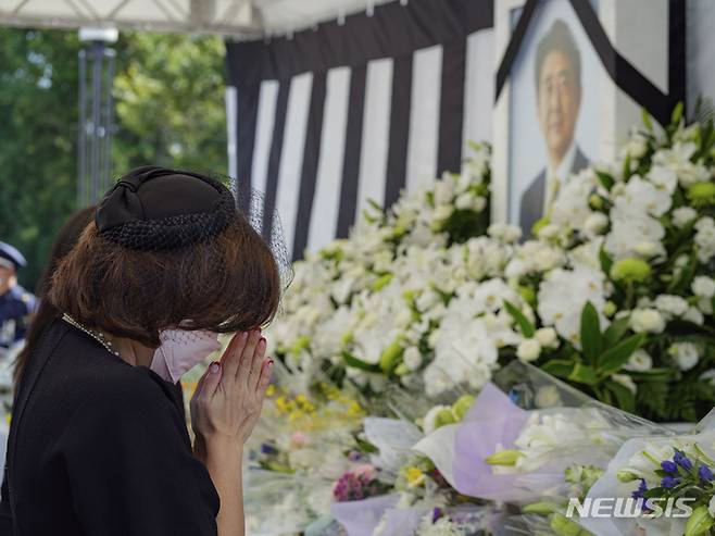 [도쿄=AP/뉴시스] 27일 일본 도쿄의 니혼부도칸 인근 구단자카 공원에서 시민들이 아베 신조 전 일본 총리의 국장에 앞서 조문하고 있다. 아베 전 총리의 국장은 이날 오후 2시에 열린다. 2022.09.27.