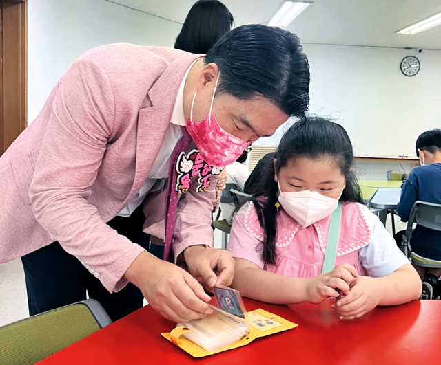 핑크 재킷을 입은 홍융희 담임목사가 초등부 어린이와 대화를 하고 있다.