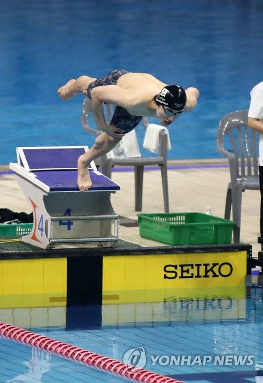 남자 접영 100m서 출발 동작을 하는 한국 수영 기대주 황선우. 검정 수영복과 캡을 쓴 모습이다. [연합뉴스 자료사진]