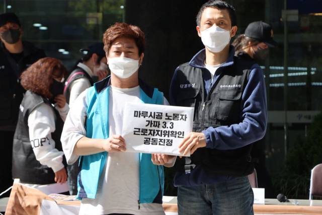 ▲13일 오전 서울 중구 서울고용노동청 본청 앞에서 열린 '마루 시공 노동자 근로자 지위 확인 공동진정 기자회견'. 공동진정 진정서를 제출하는 참여자들 ⓒ권리찾기유니온 제공