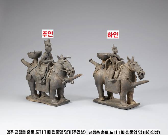 1924년 경주 금령총에서 출토된 도기 기마인물형 명기 2점. 말을 탄 인물은 주인(높이 26.8㎝)과 그 주인을 따르는 하인(높이 23.4cm)으로 해석됐다. 주인은 고깔 형상의 띠와 장식을 두른 삼각모를 쓰고, 다리 위에 갑옷으로 보이는 것을 늘어뜨렸다. 하인은 수건을 동여맨 상투머리에 웃옷을 벗은 맨몸이다. 등에는 봇짐을 메고 오른손에는 방울 같은 것을 들고 있다. 주인을 수행하는 형국이다.|국립중앙박물관 제공