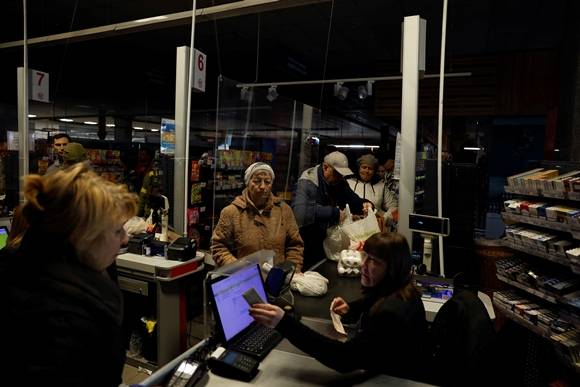 17일(현지시간) 우크라이나 하르키우에 러시아 공격으로 정전이 발생한 가운데, 주민들이 어두컴컴한 슈퍼마켓에서 장을 보고 있다. 2022.10.17 로이터 연합뉴스