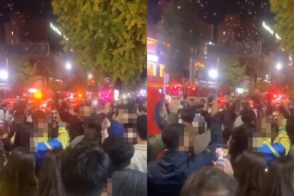 서울 용산구 이태원 압사 사고 피해자를 구조하기 위한 구급차·소방차 앞에서 단체로 노래를 부르는 영상이 30일 인스타그램과 트위터에 공개됐다. 인스타그램 캡처