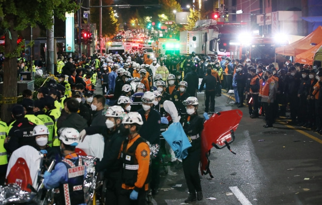 지난 29일 밤 서울 용산구 이태원 일대에서 대규모 압사사고가 발생해 30일 새벽 소방구급 대원들이 환자를 이송하고 있다. 뉴시스