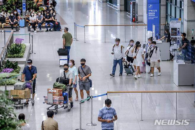 [인천공항=뉴시스] 정병혁 기자 = 코로나19가 확산되고 있는 24일 인천국제공항 1터미널에서 여행객들이 입국장을 빠져나오고 있다. 25일부터 해외입국자는 입국 1일차에 코로나19 PCR검사를 받아야한다. 방역당국에 따르면 연재 입국 3일 이내에 받는 PCR 검사를 코로나19 확산에 따라 입국 1일 이내에 받도록 하는 강화방안을 시행하기로 했다. 6월부터 입국 3일 이내로까지 완화됐던 PCR 검사 시한이 두 달만에 다시 강화됐다. 2022.07.24. jhope@newsis.com