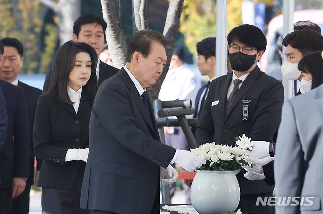 [서울=뉴시스] 전신 기자 = 윤석열 대통령과 부인 김건희 여사가 31일 서울광장에 마련된 이태원 사고 사망자 합동분향소에서 국화꽃을 집어 들고 있다. (대통령실통신사진기자단) 2022.10.31. photo1006@newsis.com