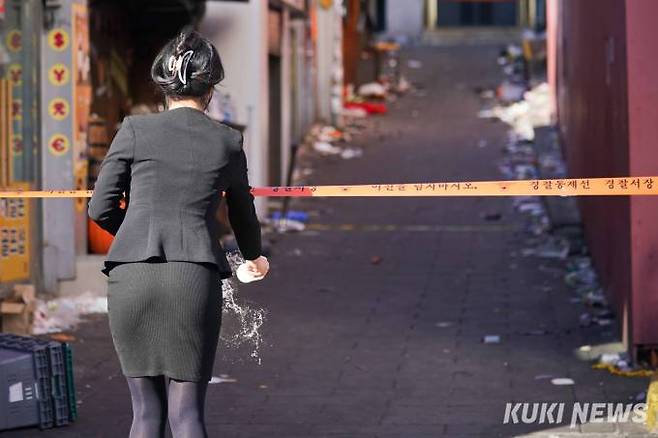 이태원 참사 발생 닷새째인 2일 오후 '이태원 참사'가 일어난 서울 용산구 이태원로 거리에서 한 시민이 추모 후 술을 뿌리고 있다.