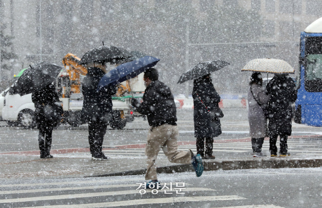 폭설이 쏟아졌던 지난해 1월 서울 광화문 네거리에서 시민들이 횡단보도를 건너고 있다. |경향신문 자료사진