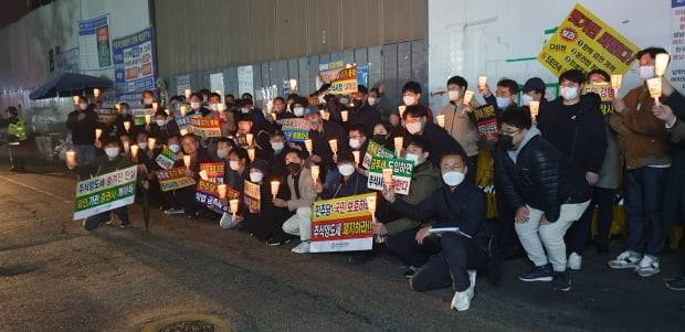 한국주식투자자연합회 등 주식 투자자들이 지난 13일 서울 여의도 더불어민주당 당사 앞에서 금융투자소득세 강행에 반대하는 촛불 시위를 벌이는 모습. 뉴스1