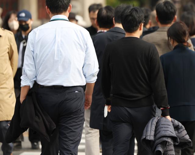 큰 추위 없이 늦가을 날씨가 이어진 21일 오후 겉옷을 손에 든 시민들이 광화문네거리를 지나고 있다. 연합뉴스