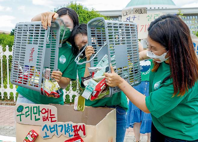 소비자기후행동 회원들이 서울 여의도 국회의사당 앞에서 열린 소비기한표시제 도입 촉구 기자회견에서 퍼포먼스를 하고 있다./사진=뉴스1