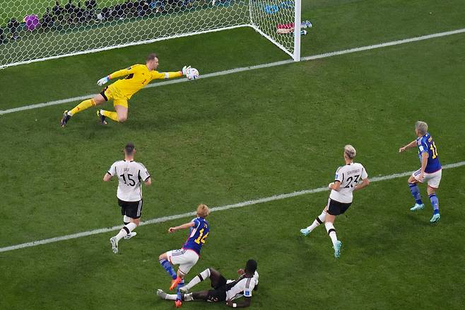 Germany's goalkeeper Manuel Neuer makes a save during the World Cup group E soccer match between Germany and Japan, at the Khalifa International Stadium in Doha, Qatar, Wednesday, Nov. 23, 2022. (AP Photo/Petr Josek)