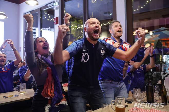 [스트라스부르=AP/뉴시스] 22일(현지시간) 프랑스 스트라스브루의 한 술집에서 TV를 통해 2022 카타르 월드컵 조별리그 D조 프랑스와 호주의 경기를 지켜보던 축구팬들이 프랑스의 득점에 열광하고 있다. 2022.11.23.