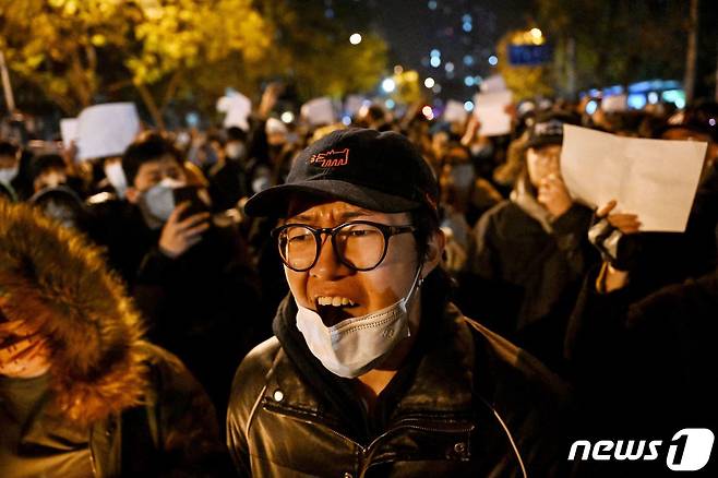 28일 중국 베이징에서 정부의 고강도 제로 코로나19 봉쇄 정책에 항의하고 우루무치 화재 희생자를 추모하는 주민이 “봉쇄 해제하라” “시진핑 물러나라” 는 구호를 외치며 밤샘 시위를 하고 있다. ⓒ AFP=뉴스1 ⓒ News1 우동명 기자