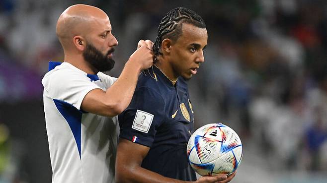 심판에게 지적받은 후 금목걸이를 풀고 있는 프랑스의 쥘 쿤데. (사진=AP/연합뉴스)