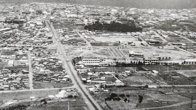 1960년말 광양로터리 부근 중앙로. 도로 가운데 1차선 정도만 아스팔트로 포장이 돼 있다. 제주 칼호텔은 당시 지어지지 않았다. (제주도)