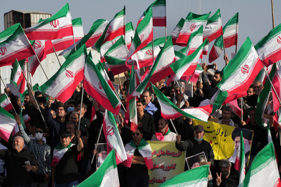 이란 테헤란에서 친정부 시위대가 반정부 시위대를 규탄하는 맞불 시위를 하면서 국기를 흔들고 있다. 반정부 시위대는 히잡 미착용으로 경찰에 구금됐다가 숨진 22세 쿠르드족 여성의 죽음에 대한 진상 규명을 요구하며 시위를 이어가고 있다. [사진=뉴시스]