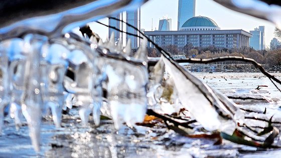 수도권 지역 한파특보가 발효된 18일 서울 여의도 인근 한강변에 꽁꽁 언 고드름 너머로 국회가 보이고 있다.뉴스1