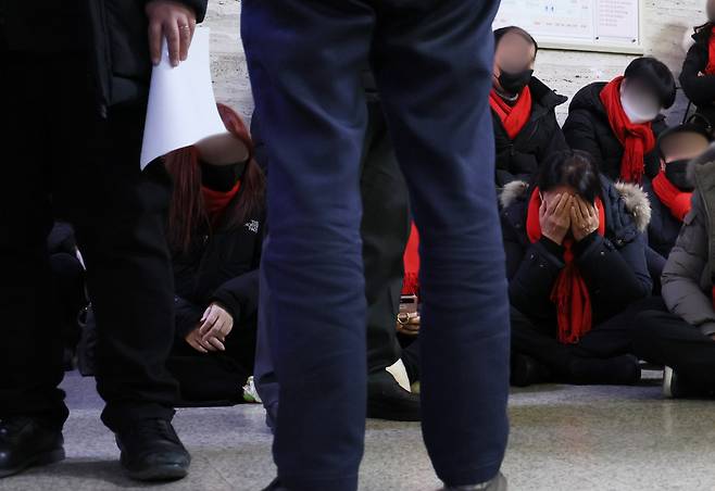 The families of the victims who died in the Itaewon disaster wait outside the conference room as the parliamentary questioning proceeds on Tuesday. (Yonhap)