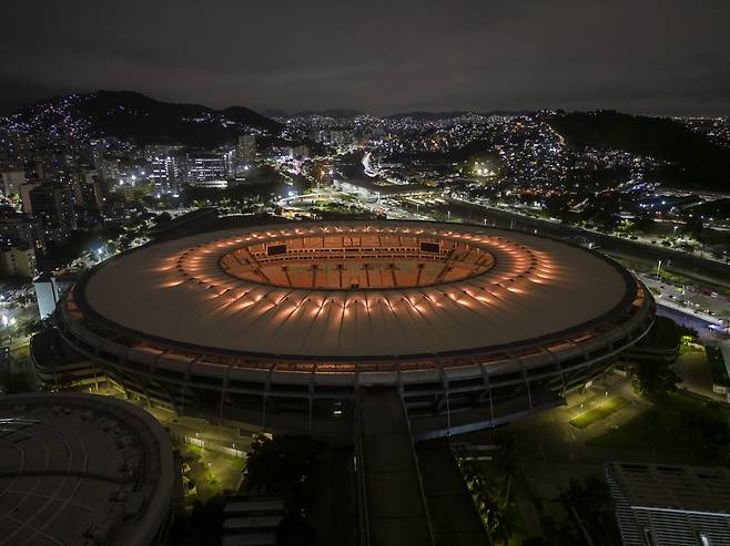 The Maracana Stadium is illuminated in yellow, one of the colors of the Brazilian national flag, to honor late soccer legend Pele in Rio de Janeiro, Brazil, Thursday. (AP)