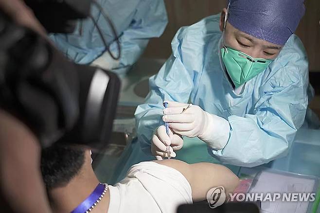 코로나19 백신 접종하는 의료진  [신화통신 연합뉴스 자료사진. 재판매 및 DB 금지]