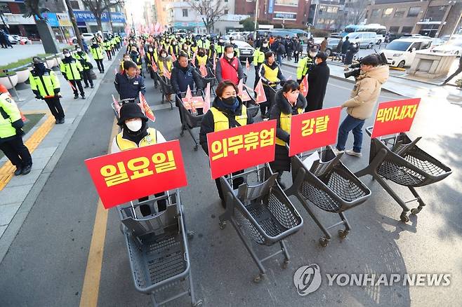 마트 노동자, 대구서 의무휴업 평일변경 추진 규탄 (대구=연합뉴스) 김현태 기자 = 4일 대구시청 동인청사 앞에서 마트 노동자들이 노동자들을 배제한 의무휴업 일방적 평일 변경 추진을 규탄하는 기자회견을 한 뒤 카트를 끌고 거리 행진을 하고 있다. 2023.1.4 mtkht@yna.co.kr