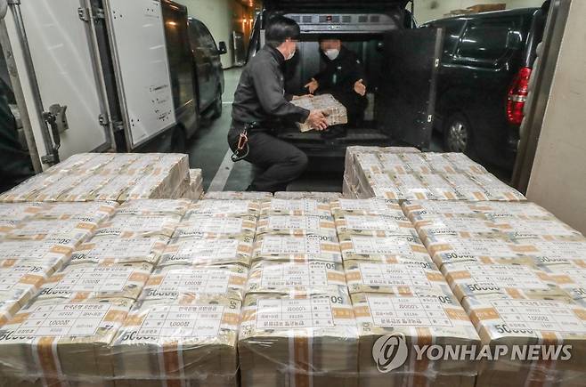 설 자금 방출 (서울=연합뉴스) 설 명절을 일주일 앞둔 16일 서울 강남구 한국은행 강남본부에서 현금 운송 관계자들이 시중은행에 공급될 설 자금 방출 작업을 하고 있다. 2023.1.16 [사진공동취재단] photo@yna.co.kr