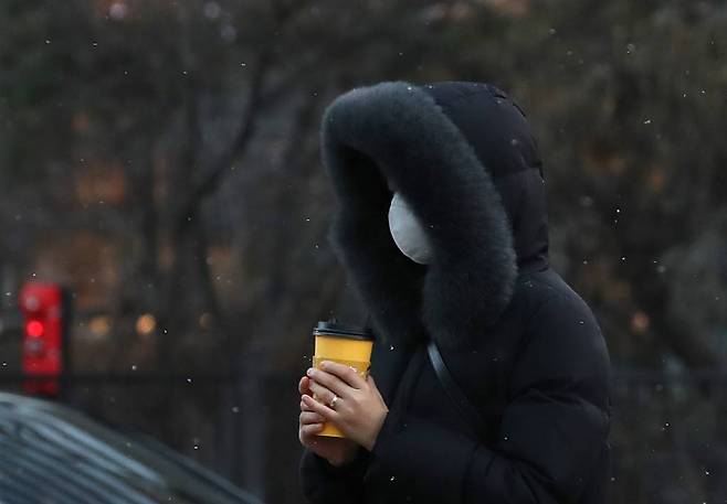 [서울=뉴시스] 조수정 기자 = 서울·경기·강원 지역 등에 한파특보가 내려진 16일 오전 서울 세종로사거리에서 시민들이 눈을 맞으며 출근하고 있다. 2023.01.16.