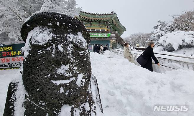 [제주=뉴시스] 우장호 기자 = 제주 한라산 1100고지에 서 있는 돌하르방이 눈 속에 묻혀 있다. 2022.12.26. woo1223@newsis.com