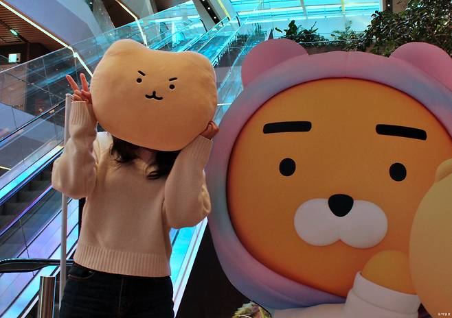 지난달 초 경기 성남시 카카오 판교 아지트에서 이모티콘 작가 유랑이 자신의 대표적 ‘망그러진 곰’의 캐릭터 상품 중 하나인 쿠션을 들고 사진을 찍고 있다. 카카오 제공