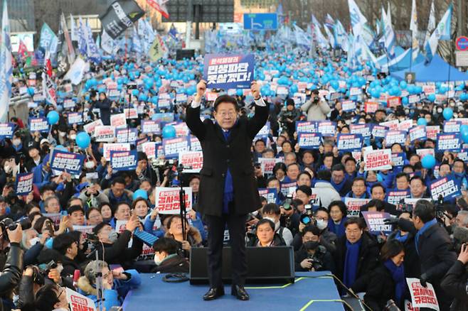 이재명 더불어민주당 대표가 4일 오후 서울 숭례문 인근 세종대로에서 열린 윤석열 정권 민생파탄 검사독재 규탄대회에서 무대에 올라 정부 규탄 손팻말을 들고 있다. 연합뉴스